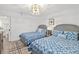 Bright bedroom featuring two twin beds with stylish bedding and contemporary chandelier at 2425 S Atlantic Ave # 1202A, Daytona Beach Shores, FL 32118