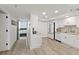 Galley kitchen with stainless appliances, white cabinets, granite countertops, and wood-look tile flooring at 2425 S Atlantic Ave # 1202A, Daytona Beach Shores, FL 32118