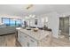 A well-lit open kitchen features a large central island with seating and a view of the living space at 2425 S Atlantic Ave # 1202A, Daytona Beach Shores, FL 32118