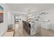 Spacious kitchen features a large island with seating, white cabinets, and modern lighting at 2425 S Atlantic Ave # 1202A, Daytona Beach Shores, FL 32118
