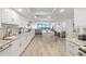 Bright, open kitchen with granite countertops and white cabinets, offering ocean views at 2425 S Atlantic Ave # 1202A, Daytona Beach Shores, FL 32118