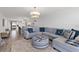 Open-concept living space featuring coastal decor, large sectional seating, and seamless flow into the kitchen at 2425 S Atlantic Ave # 1202A, Daytona Beach Shores, FL 32118