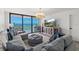 Coastal living room featuring stylish decor, ocean views, and a media center with a large flatscreen TV at 2425 S Atlantic Ave # 1202A, Daytona Beach Shores, FL 32118