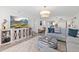 Open-concept living space featuring coastal decor, large sectional seating, and a flatscreen TV at 2425 S Atlantic Ave # 1202A, Daytona Beach Shores, FL 32118