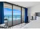Bright main bedroom with ocean view, sliding glass door, and modern decor at 2425 S Atlantic Ave # 1202A, Daytona Beach Shores, FL 32118