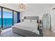 Bright main bedroom with ocean view, sliding glass door, and modern decor at 2425 S Atlantic Ave # 1202A, Daytona Beach Shores, FL 32118