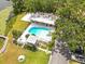 Aerial view of a private pool with a surrounding patio, lush greenery, and lake access at 2500 Lee Rd # 134, Winter Park, FL 32789