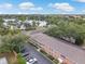Aerial view of the condominium complex near a picturesque lake and lush greenery at 2500 Lee Rd # 134, Winter Park, FL 32789