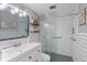 Bright bathroom featuring a subway tile shower, decorative shelves, and sleek vanity at 2500 Lee Rd # 134, Winter Park, FL 32789