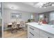 Open-concept dining area with bright table, patterned chairs, and connection to the kitchen and living areas at 2500 Lee Rd # 134, Winter Park, FL 32789