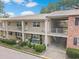 Two-story condo building with front patios, lush landscaping, and convenient parking at 2500 Lee Rd # 134, Winter Park, FL 32789