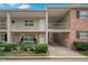 Two-story condo with front patios, lush landscaping, and designated parking below at 2500 Lee Rd # 134, Winter Park, FL 32789