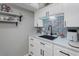 Cozy kitchen featuring white cabinets, modern black hardware, and stylish tile backsplash at 2500 Lee Rd # 134, Winter Park, FL 32789
