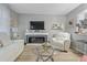 Cozy living room featuring white furniture, modern fireplace, and open layout at 2500 Lee Rd # 134, Winter Park, FL 32789