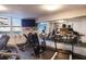 Fitness center featuring cardio equipment, weights, and a mirrored wall at 2800 N Atlantic Ave # 206, Daytona Beach, FL 32118