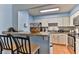 Charming kitchen area with an open floor plan and stainless steel appliances at 2800 N Atlantic Ave # 206, Daytona Beach, FL 32118
