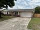 Charming single-story home with a well-maintained lawn, brick accents, and an attached two-car garage at 2841 Beal St, Deltona, FL 32738