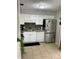 Bright kitchen featuring white cabinets, stainless steel appliances, and a stylish backsplash at 2841 Beal St, Deltona, FL 32738