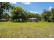 Sprawling yard with scattered trees and a small outbuilding for a serene atmosphere at 29505 North, Paisley, FL 32767
