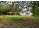 Picturesque single-story home nestled among trees, complemented by a spacious front yard at 29505 North, Paisley, FL 32767