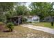 Welcoming single-story house with a covered carport and a well-maintained lawn at 29505 North, Paisley, FL 32767