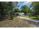 Charming home with a covered carport and a driveway surrounded by greenery at 29505 North, Paisley, FL 32767