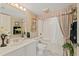 Bathroom featuring a vanity, commode and combination shower and tub at 2967 S Atlantic Ave # 202, Daytona Beach Shores, FL 32118