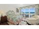 This bedroom features beautiful ocean views, a private balcony, and a relaxing sitting area at 2967 S Atlantic Ave # 202, Daytona Beach Shores, FL 32118