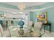 View of dining room featuring a modern chandelier, painting, and breakfast bar to the kitchen at 2967 S Atlantic Ave # 202, Daytona Beach Shores, FL 32118