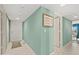 Welcoming hallway with neutral tones and tiled flooring, leading to various rooms within the home at 2967 S Atlantic Ave # 202, Daytona Beach Shores, FL 32118