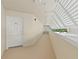 Bright hallway with natural light and views of the surrounding greenery, leading to the entrance at 2967 S Atlantic Ave # 202, Daytona Beach Shores, FL 32118
