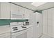 Bright kitchen featuring modern white appliances and cabinets at 2967 S Atlantic Ave # 202, Daytona Beach Shores, FL 32118
