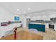 Bright kitchen with white cabinets, blue island, stainless steel appliances, and table for dining at 2967 S Atlantic Ave # 202, Daytona Beach Shores, FL 32118