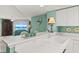 Open view of the kitchen and breakfast bar overlooking the living area with ocean views at 2967 S Atlantic Ave # 202, Daytona Beach Shores, FL 32118