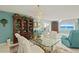 Inviting space featuring a glass table, a large bookshelf, and ocean views through the windows at 2967 S Atlantic Ave # 202, Daytona Beach Shores, FL 32118