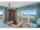 Inviting main bedroom featuring a seating area, beachfront balcony, and ample natural light at 2967 S Atlantic Ave # 202, Daytona Beach Shores, FL 32118