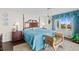 Cozy bedroom featuring dark wood floors and furniture with floral bedding and ocean view at 2967 S Atlantic Ave # 202, Daytona Beach Shores, FL 32118