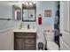 Stylish bathroom with a modern vanity, updated fixtures, and wainscoting detail at 3001 Inca Ct, Deltona, FL 32738
