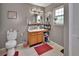 Functional bathroom with a vanity, toilet, and a bright window providing natural light at 3001 Inca Ct, Deltona, FL 32738