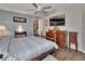 Comfortable bedroom with wood floors, a traditional dresser, and a large screen TV at 3001 Inca Ct, Deltona, FL 32738
