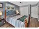 Comfortable bedroom with blue accent wall, a large bed, and a closet at 3001 Inca Ct, Deltona, FL 32738