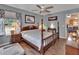 Bright bedroom with hardwood floors, a four-poster bed, and a view of the outdoors at 3001 Inca Ct, Deltona, FL 32738