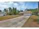 Charming home exterior with a long driveway leading to an attached garage at 3001 Inca Ct, Deltona, FL 32738