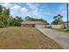 Exterior view of a single-story home featuring a paved driveway at 3001 Inca Ct, Deltona, FL 32738