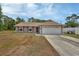 Charming single-story home with a two car garage and red shutters, surrounded by trees at 3001 Inca Ct, Deltona, FL 32738