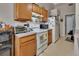 Cozy kitchen with wooden cabinets, a white oven, and tiled floors, perfect for comfortable cooking at 3001 Inca Ct, Deltona, FL 32738