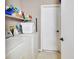 Practical laundry room with washer, dryer, and ample shelving for storage at 3001 Inca Ct, Deltona, FL 32738