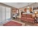 Bright living room with sliding glass doors, a cozy sofa, and an adjacent kitchen at 3001 Inca Ct, Deltona, FL 32738