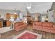 Open concept living room with hardwood floors, a view of the kitchen, and dining area at 3001 Inca Ct, Deltona, FL 32738