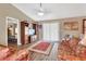 Cozy living room featuring a large TV cabinet, ceiling fan, and lots of natural light at 3001 Inca Ct, Deltona, FL 32738